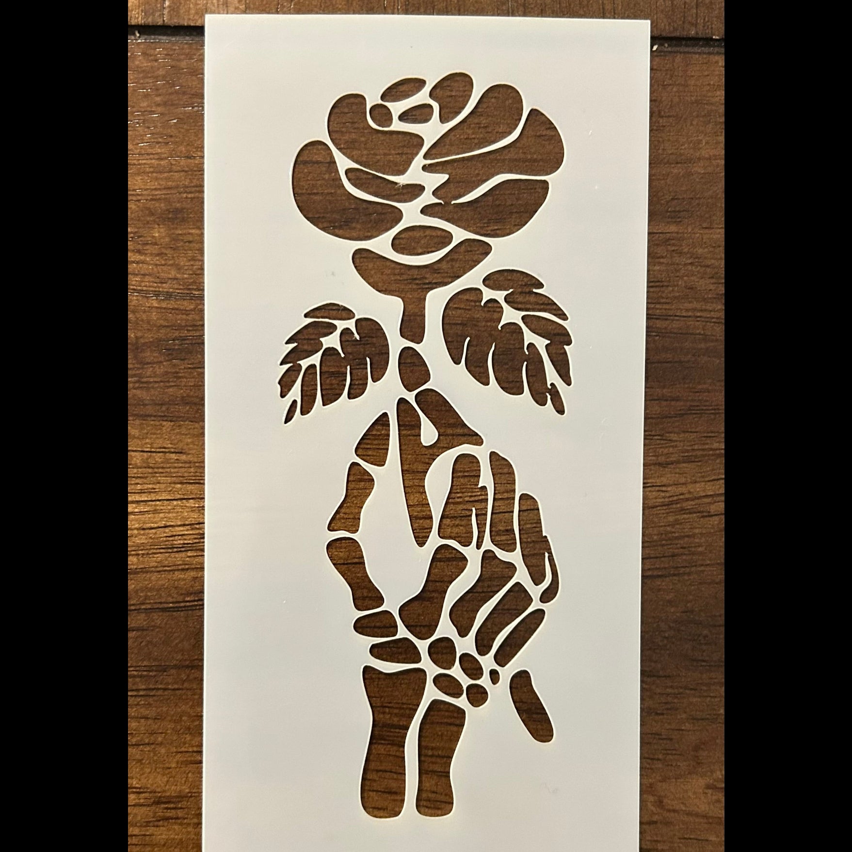 Skelton and  hand with 
rose stencil