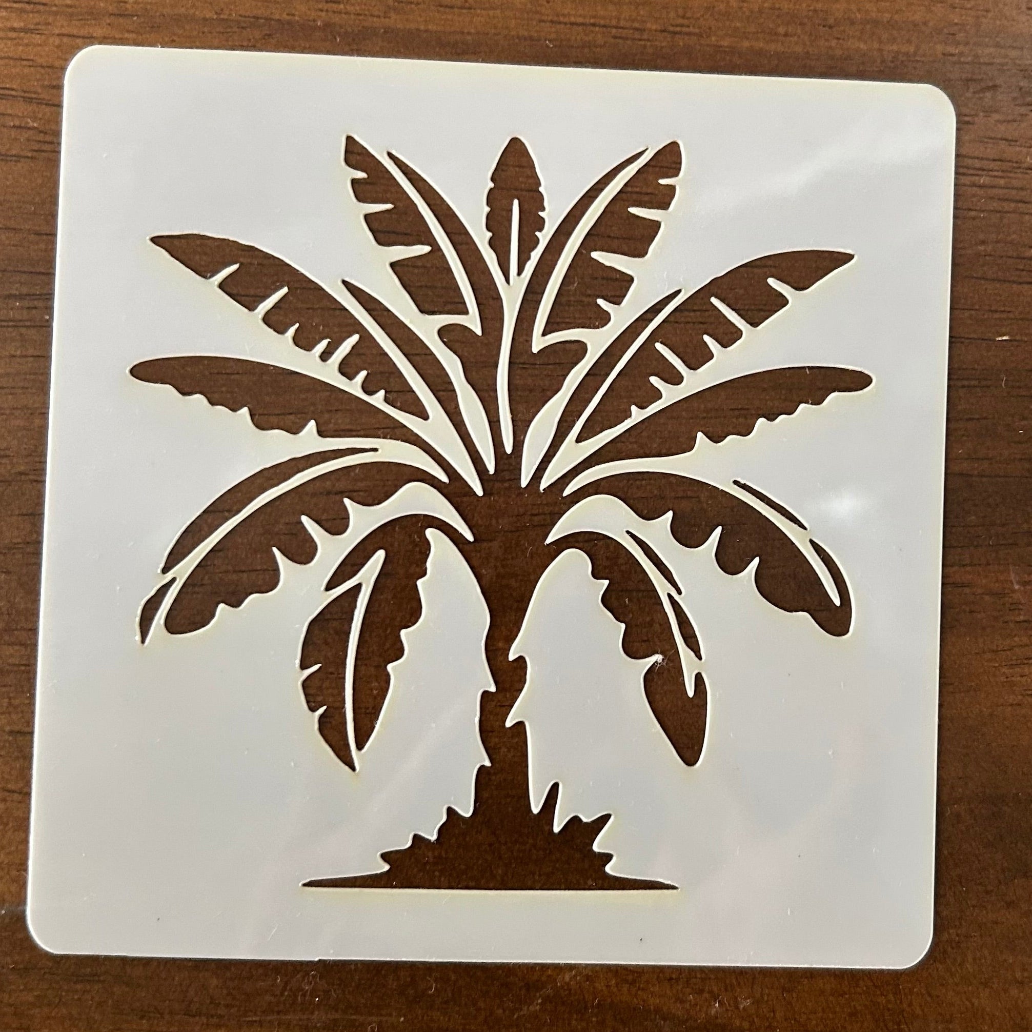 Palm tree design on a white square background