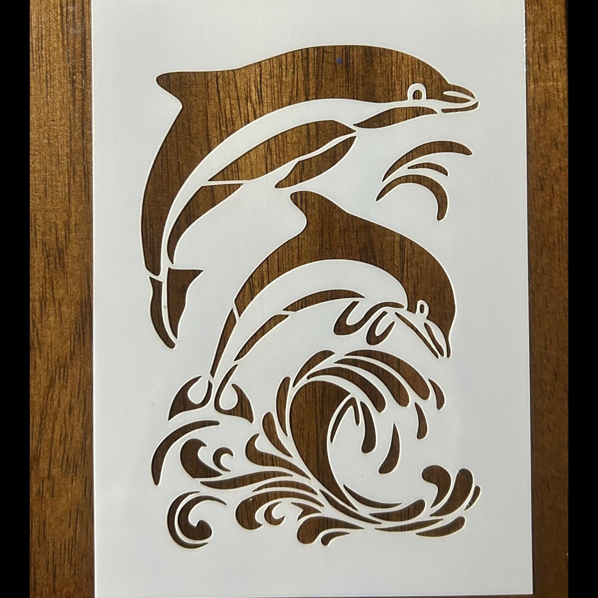Stylized illustration of dolphins on a white card with a wooden background