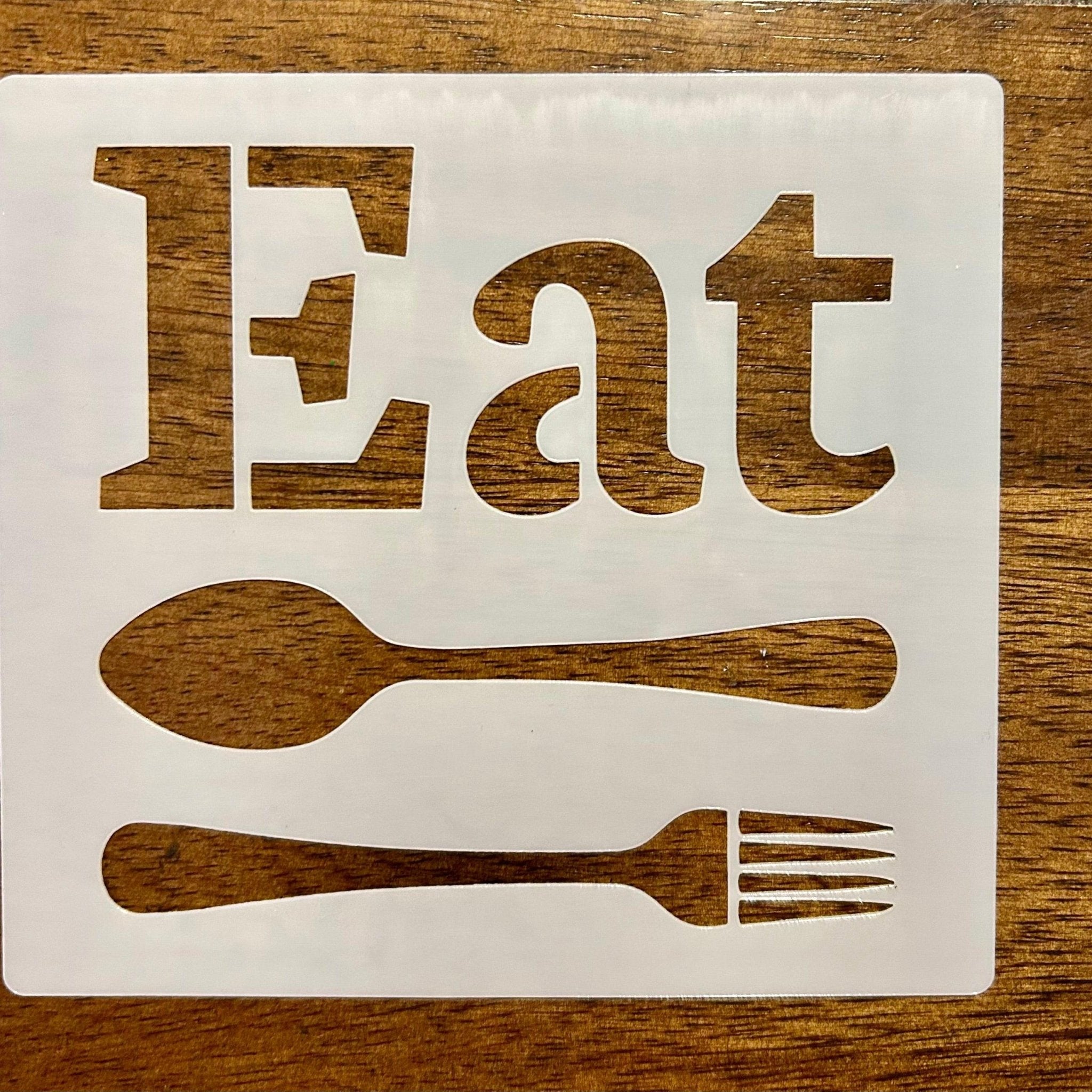 ‘Eat' sign with spoon and fork on a wooden background